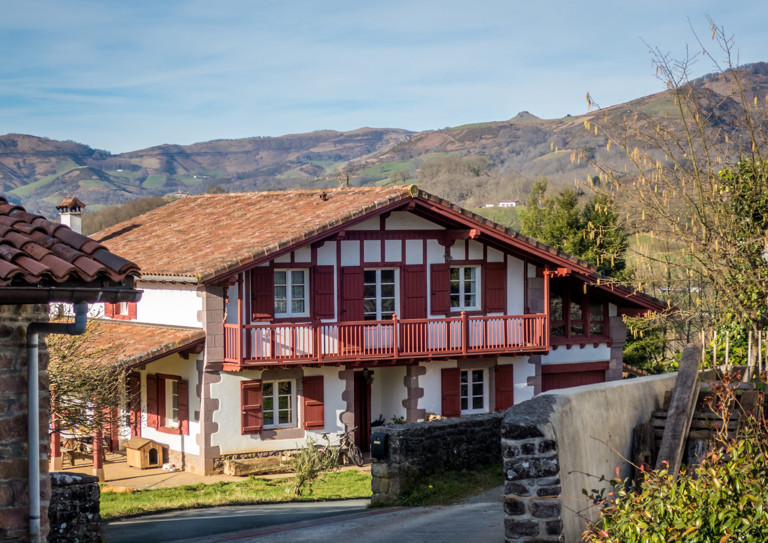 A large house surrounded by mountains and trees